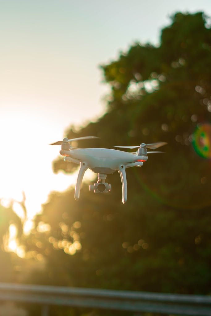 A drone flying amidst the greenery during sunset, capturing serene aerial views.